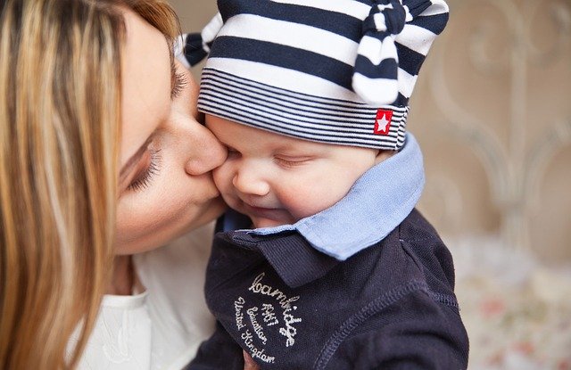 Woman kissing a baby